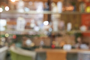 Fototapeta premium Retail Cafe Counter Showing Soft Blurred Merchandise And Bokeh Lighting In Cozy Shop Interior Environment With Warm Tones And Layered Shelving.