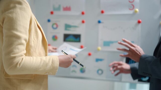 Business Team Discussing Strategy at Whiteboard
