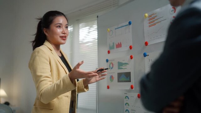 Businesswoman Presenting Financial Charts in Office