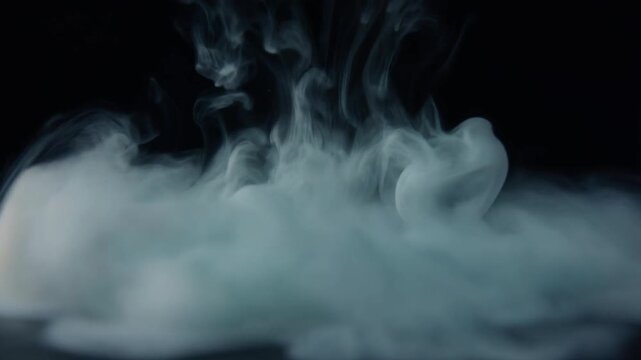 Cool silver mist dispersing across dark surface