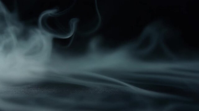 Cool silver mist disperses and thins across dark surface, soft wisps fading gradually under cool backlighting with ethereal atmosphere, subtle glow, and minimalist cinematic motion.