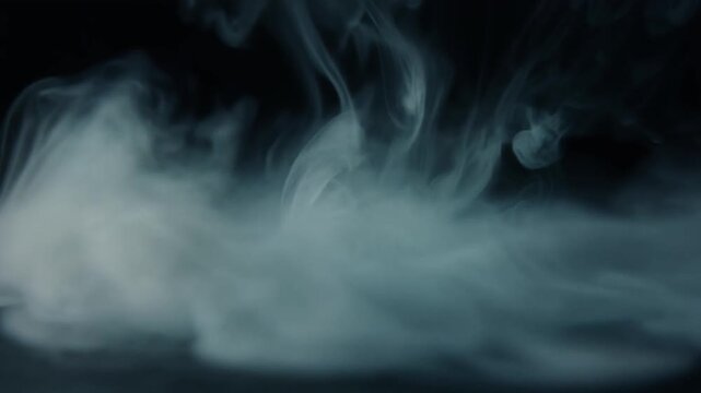 Cool silver mist dispersing across dark surface