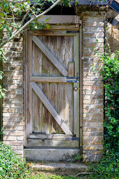 Old Wooden Door and Brick Wall on the Side of an Historic Residence