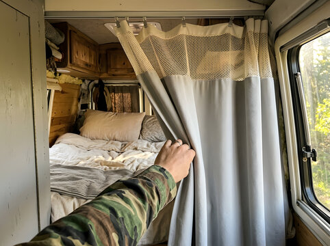 Hand Opening Privacy Curtain in Camper Van Cozy Bed Area | Person Drawing Back Curtain inside Custom RV Van Bed Interior | Pulling Curtain in Modern Camper Van Living Space Close Up