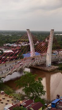 A view of Banjarmasin city and the Alalak River Bridge (or Basit Handil Bakti Bridge) in the sunset
