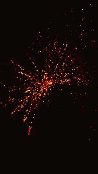 Golden fireworks exploding in the night sky