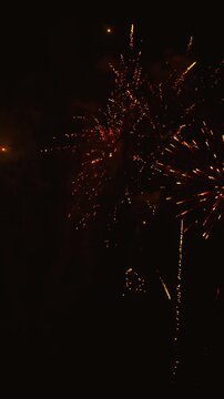 Spectacular golden and red fireworks exploding at night