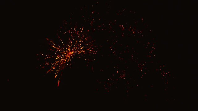 Golden fireworks exploding in the night sky