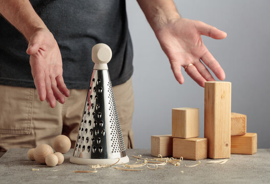 Man grating wooden blocks into round shapes, illustrating pointless work, wasted effort and an inefficient process.