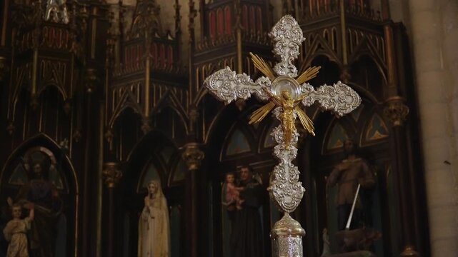 Cross with a crucifix inside a church