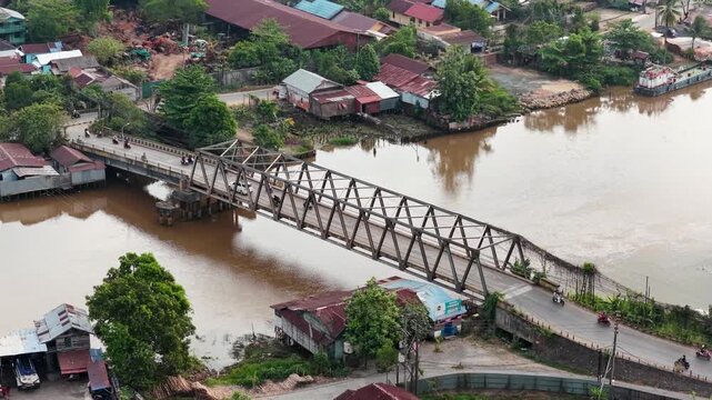 A view of Banjarmasin city and the Alalak River Bridge (or Basit Handil Bakti Bridge) in the sunset