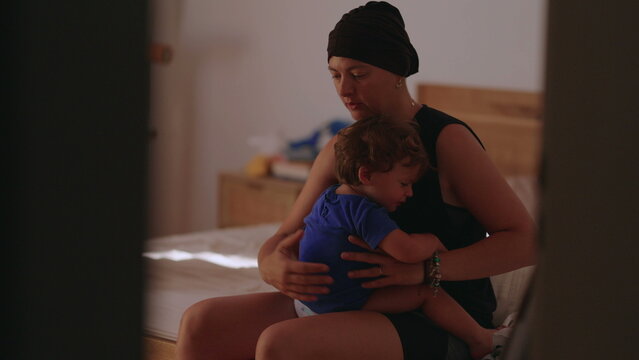 Mother embracing toddler on bed at home, highlighting comfort, emotional security and maternal love