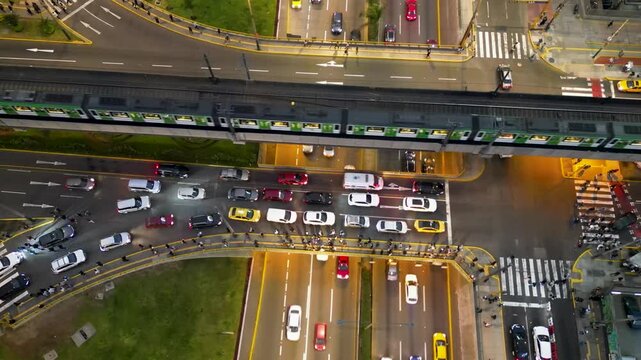 Top-down aerial view of heavy rush hour traffic at the busy Javier Prado and San Luis intersection in Lima, Peru.