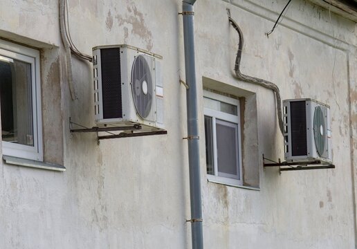 Wall-Mounted HVAC Split System Air Conditioner Outdoor Units on an Old Building Facade