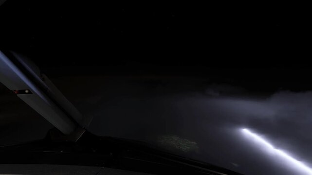 cockpit view at night with lighting thunder
