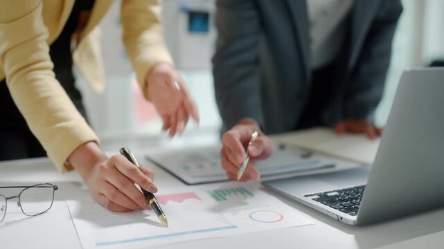 Business Team Reviewing Financial Charts in Office