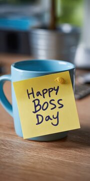 Happy boss day sticky note on coffee mug
