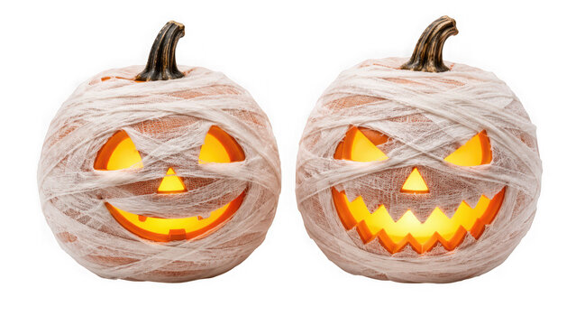 Two mummy pumpkins wrapped in gauze with glowing faces isolated on transparent background