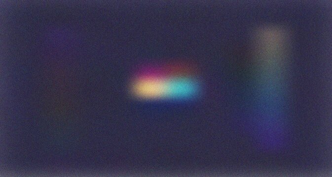 Subtle abstract rainbow spectrum light blur on a muted dark blue violet grainy textured surface