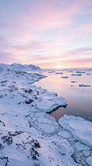 Naklejka premium Snowy arctic coastline with icebergs floating in the ocean during a pink sunset, representing climate change and polar wilderness in a remote northern landscape.