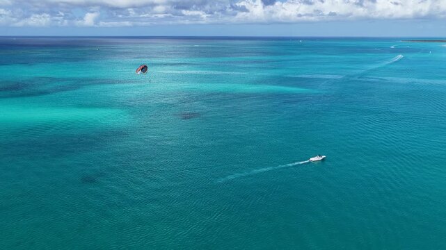 Parasailing At Providenciales In Turks And Caicos. Idyllic Beach. Nature Landscape. Aquatic Sport. Parasailing In Turks And Caicos. Aquatic Sport Landscape.