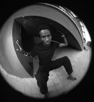 Circular fisheye black and white portrait of expressive man with concrete copy space