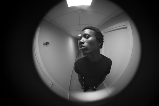 Circular fisheye black and white portrait of man in corridor with copy space