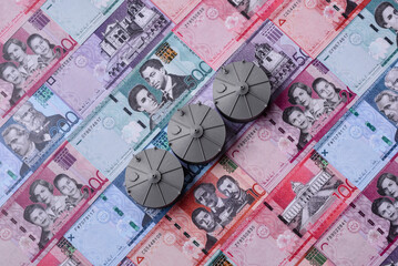 Fototapeta premium Liquefied gas storage tanks set against the Dominican money as a background for your design