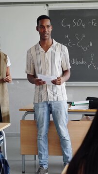 High School Student Presenting Science Project in Front of Classroom with Teacher
