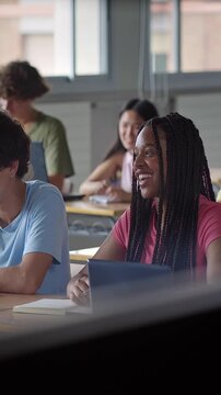 Class of teenager students listening to teacher lecture at college school classroom