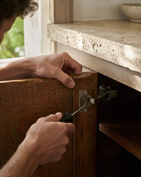 Repairing a Loose Cabinet Hinge in a Modest Kitchen