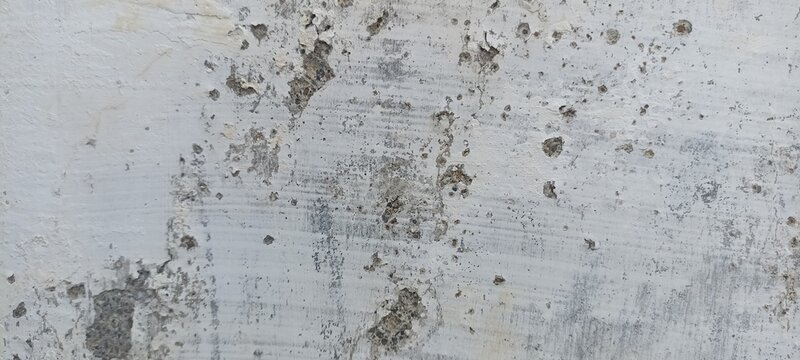 White Concrete Wall Texture with chipped paint, exposed aggregate, and weathered details, ideal for grunge backgrounds, architectural designs, construction concepts, and overlays