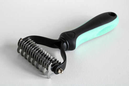 Cat Dematting Comb for Removing Mats and Tangles from Fur on White Background
