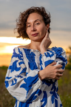 Woman in Blue Off-Shoulder Dress at Sunset
