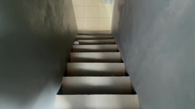 Walking down concrete stairs into basement or lower floor