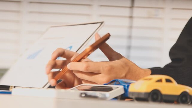 Car sale or rental concept, Closeup Dealership manager signing car insurance document or lease paper contract. Customer with car dealer agent making deal, sign on agreement document contract in office