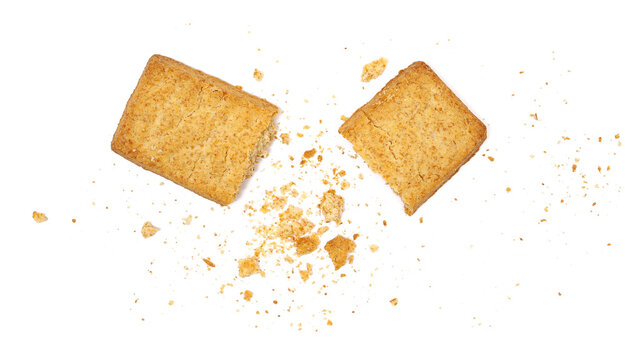 Wholemeal cookies pieces and crumbs, isolated on white background and texture, explosion effect, top view, design element