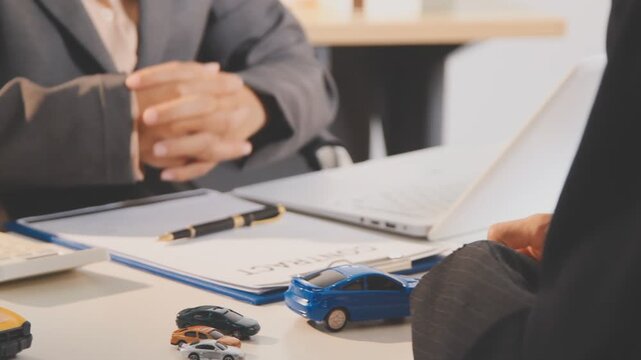 Car sale or rental concept, Closeup Dealership manager signing car insurance document or lease paper contract. Customer with car dealer agent making deal, sign on agreement document contract in office
