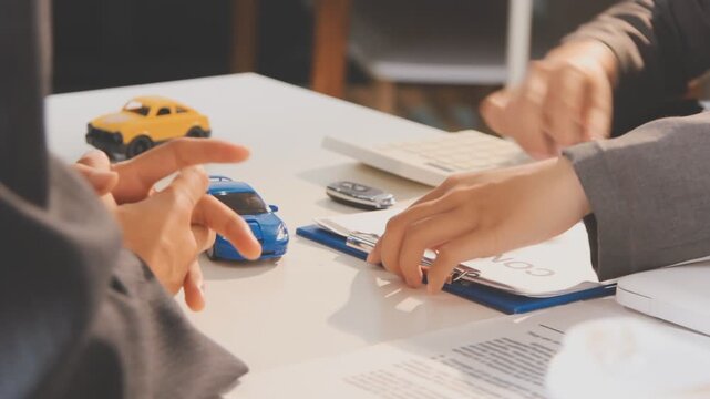 Car sale or rental concept, Closeup Dealership manager signing car insurance document or lease paper contract. Customer with car dealer agent making deal, sign on agreement document contract in office