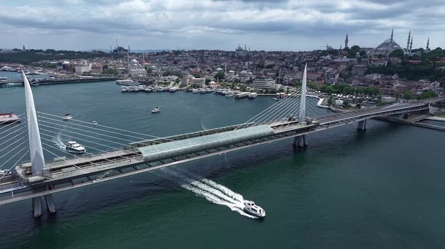 Ferry Passing Under Hali&ccedil; Bridge in Istanbul with Golden Horn Aerial View