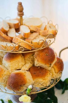 elegant tiered bread display at an indoor event gathering close-up slightly elevated view of sliced.