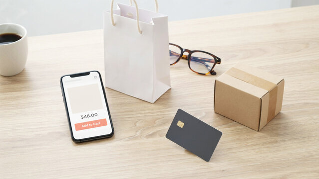 Online shopping payment process displayed on smartphone with shopping bag card and delivery box