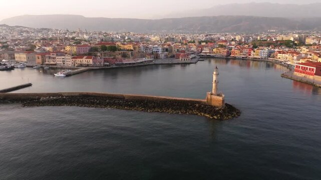  View of Chania with the amazing lighthouse, mosque, venetian shipyards, Crete, Greece.Waves crashing on lighthouse, Beautiful Greece and best scenic places - panorama