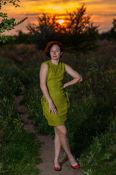 Woman in Green Dress on Sunset Path