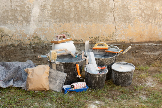 Home renovation with building materials, plaster, paint, and tools for interior construction and finishing work. Concept: high prices for construction work and finishing materials.