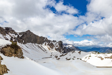 Snow covers the mountains in Bad Hindelang, Allgäu, Germany, as clouds drift above. © wagner_md