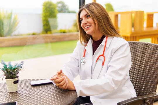 Female doctor smiling wearing white coat and stethoscope