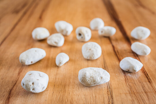 Andean white chu&ntilde;o in an ancestral ceramic pot and plate on a wooden table, raw organic chu&ntilde;os for a healthy vegetarian kitchen and natural nutrition.