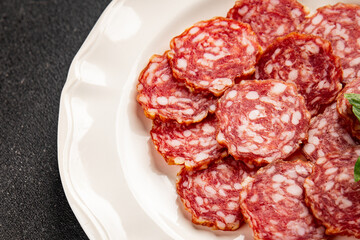 Obraz premium Sausage slices salami cured sausages meat food preparation dish tasty snack fresh and delicious gourmet rustic food background on the table&nbsp; rustic food top view copy space