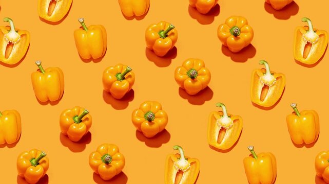 Colorful bell peppers moving on bright orange background in stop motion pattern. Concept of grocery advertising, healthy eating campaigns, recipe intros and colorful food backgrounds.